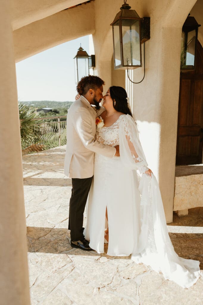 A couple having an intimate wedding ceremony at Chapel Dulcinea in Austin, Texas, on a sunny day, with clear skies and natural surroundings.