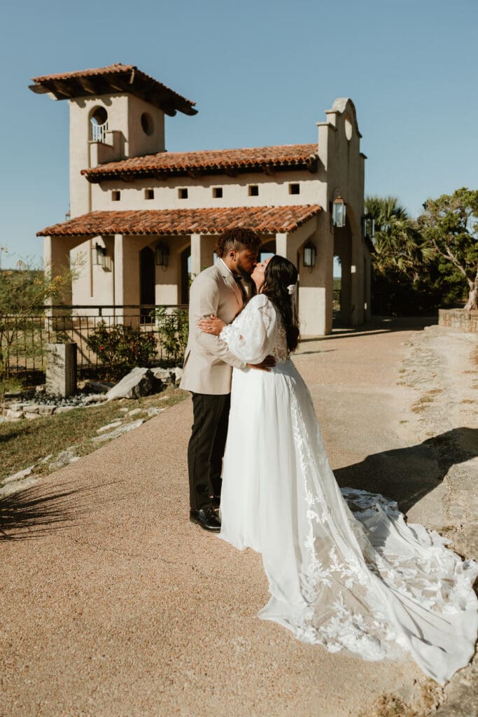 A couple having an intimate wedding ceremony at Chapel Dulcinea in Austin, Texas, on a sunny day, with clear skies and natural surroundings.