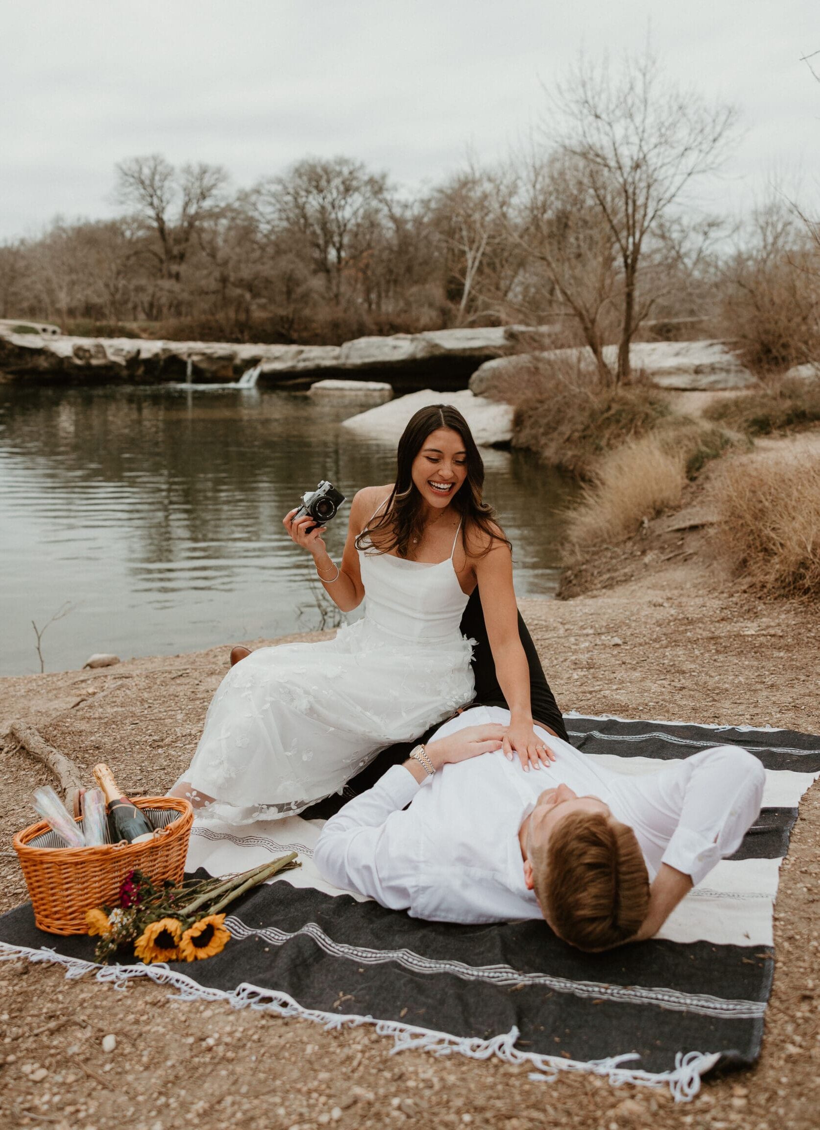 Engaged couple enjoying picnic at a rocky state park