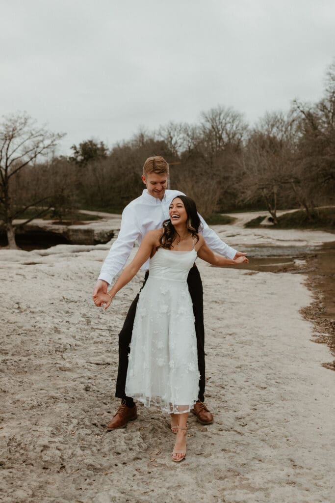 An engaged overlooking the cliffs at McKinney Falls State Park.