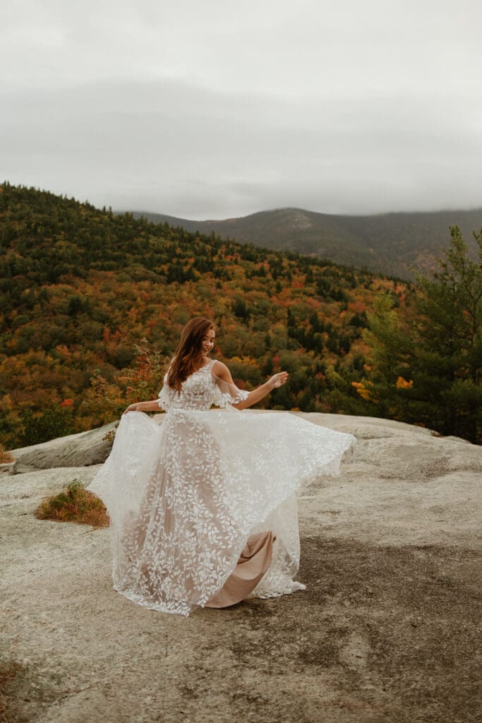 A couple eloping on a cloudy autumn evening in the mountains of New Hampshire, surrounded by colorful fall foliage.