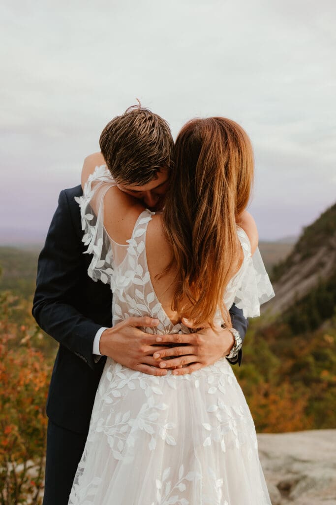 A couple eloping on a cloudy autumn evening in the mountains of New Hampshire, surrounded by colorful fall foliage.