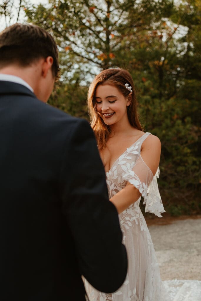 A couple eloping on a cloudy autumn evening in the mountains of New Hampshire, surrounded by colorful fall foliage.