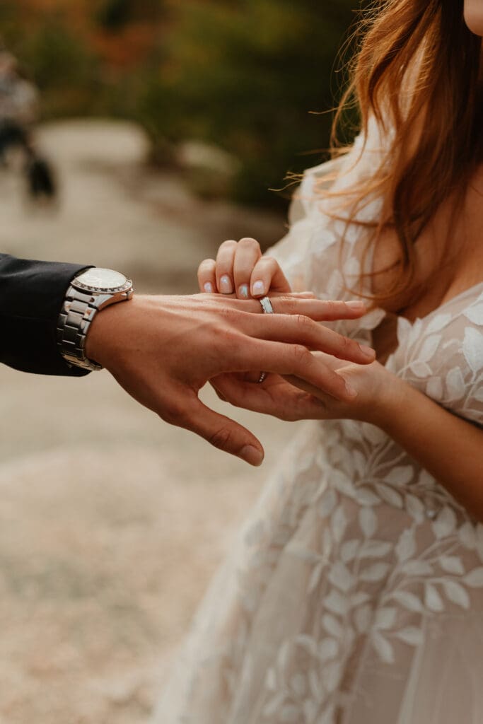 A couple eloping on a cloudy autumn evening in the mountains of New Hampshire, surrounded by colorful fall foliage.