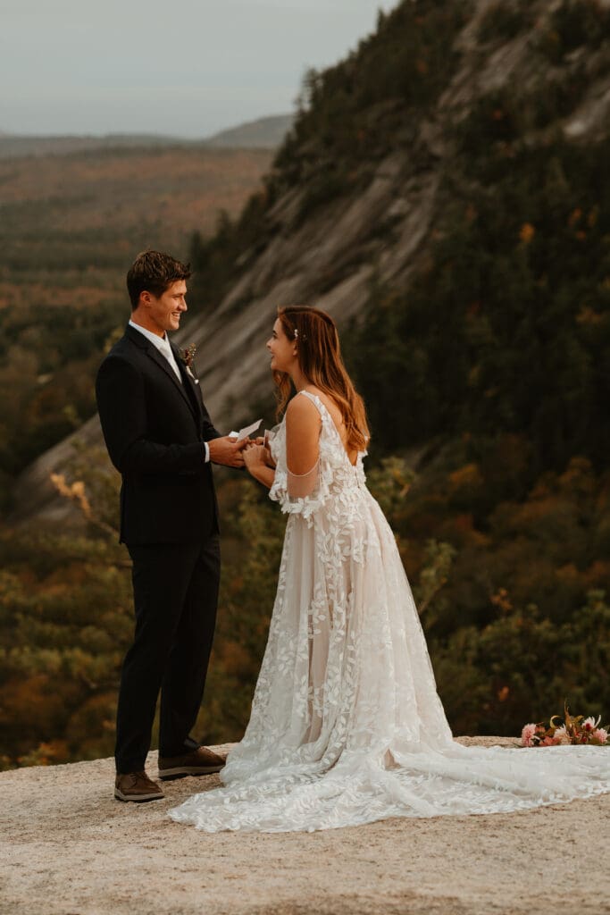 A couple eloping on a cloudy autumn evening in the mountains of New Hampshire, surrounded by colorful fall foliage.