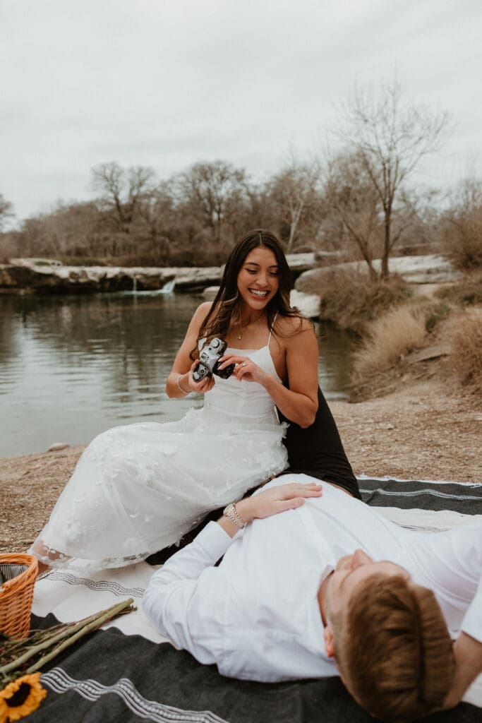 A newly engaged couple being playful at McKinney Falls State Park in Austin Texas.
