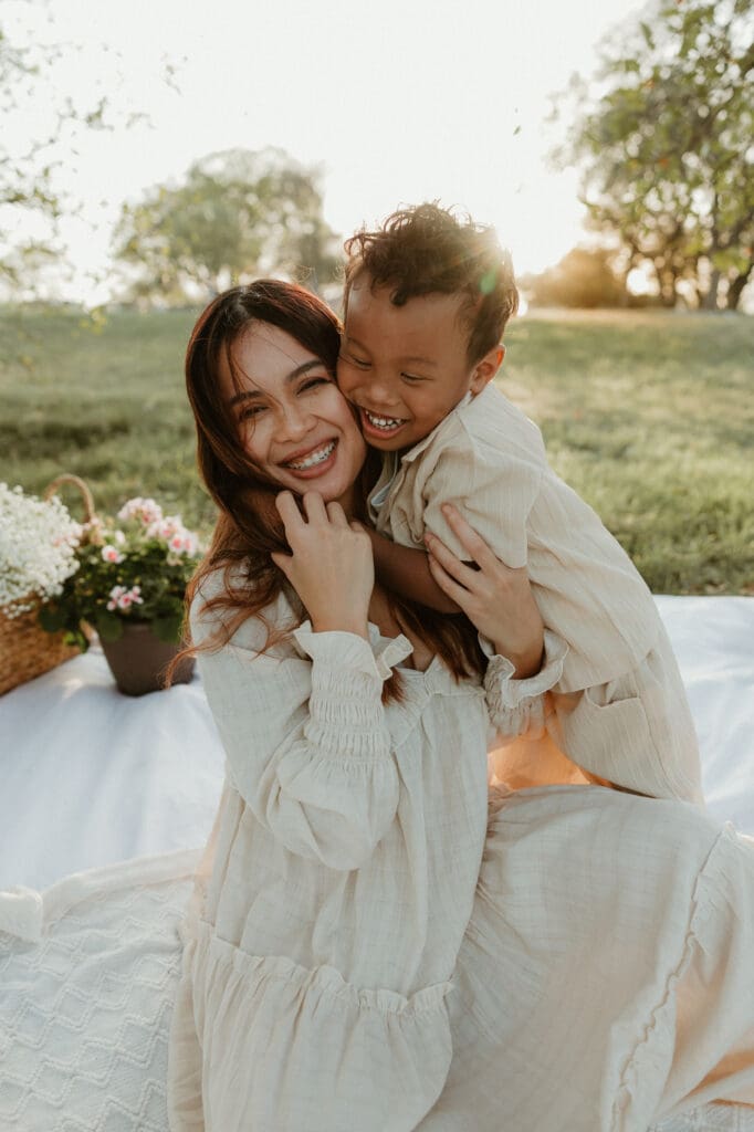 Son sneak attack hugs mom during a beautiful golden hour in North Austin. 
