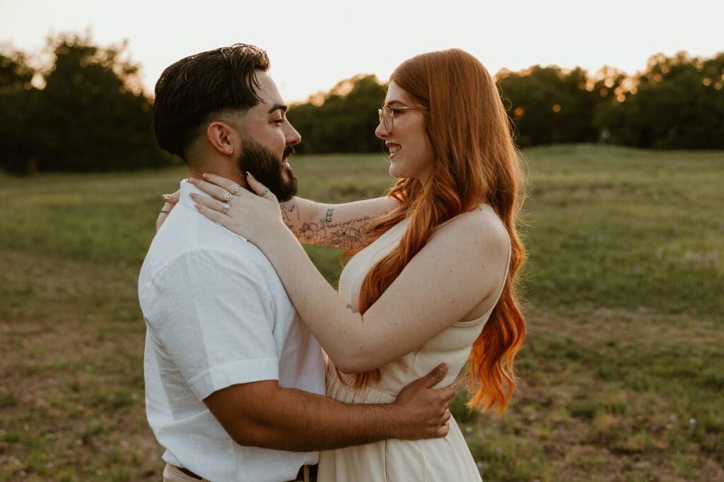 Couple sharing happy glances in a flower field at Brushy Creek Lake Park. 