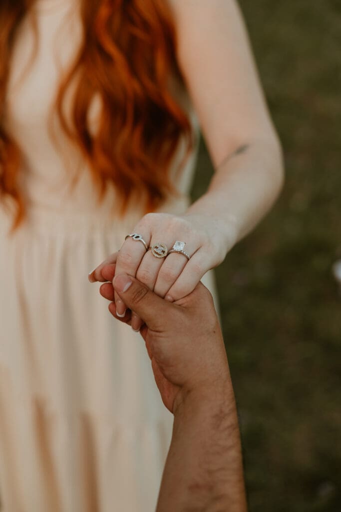 Close up of hand with engagement ring after proposal during photo session at Brushy Creek Lake Park in Cedar Park. 
