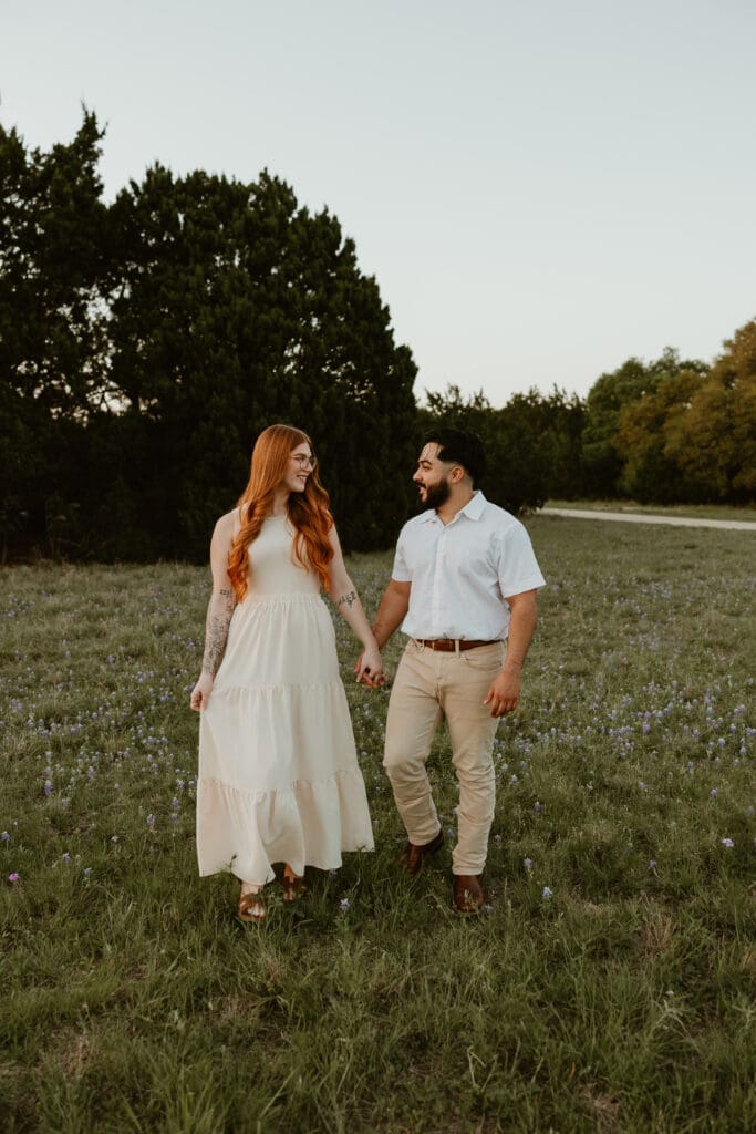 Couple frolicking through a flower field at Brushy Creek Lake Park in Cedar Park, Texas. 