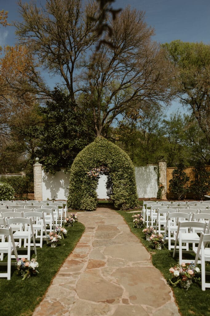 Outdoor wedding ceremony under oak trees at The Hummingbird House Austin wedding venue
