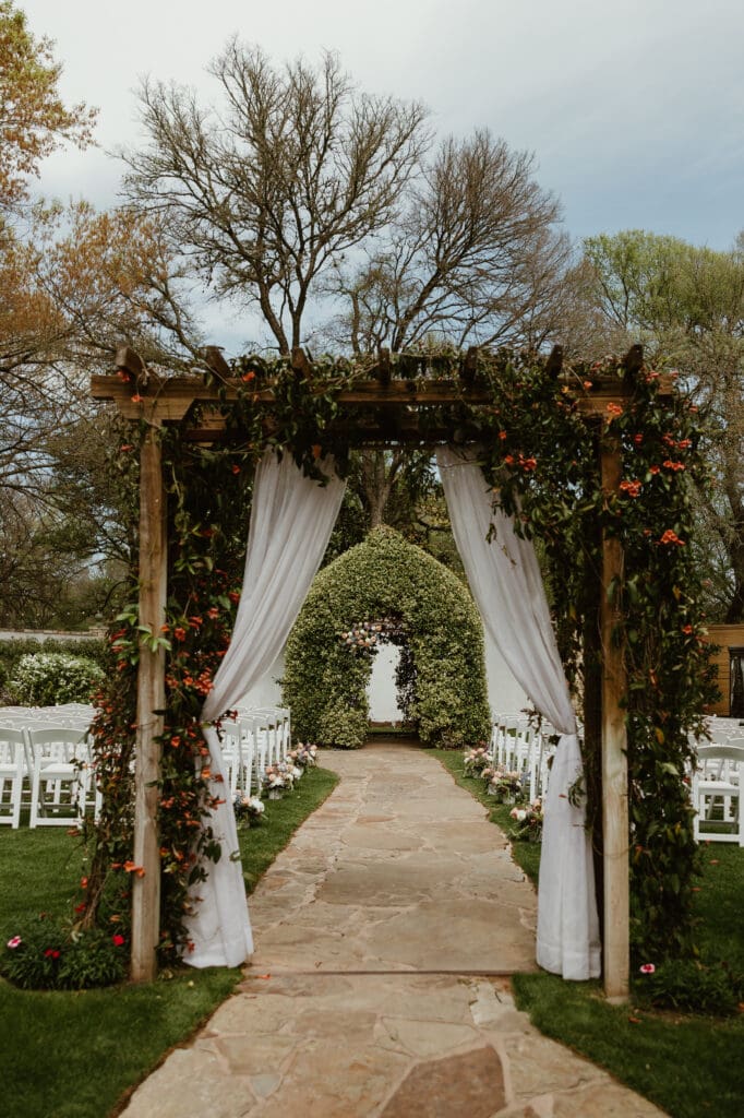 Outdoor wedding ceremony under oak trees at The Hummingbird House Austin wedding venue