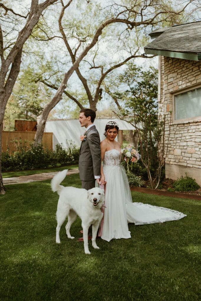 First touch moments between bride and groom at The Hummingbird House garden venue near Austin