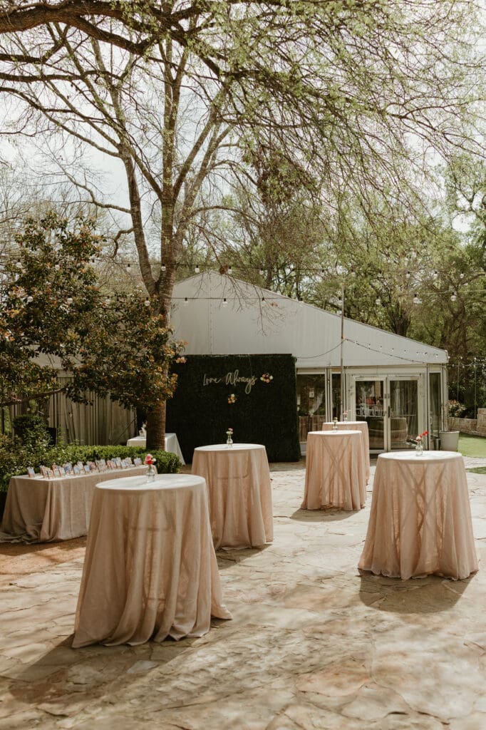 Outdoor wedding ceremony cocktail hour under oak trees at The Hummingbird House Austin wedding venue