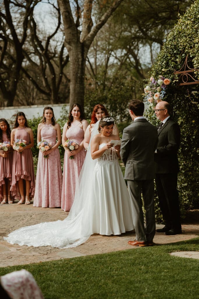 Bride exchanging vows during ceremony at The Hummingbird House near Austin TX