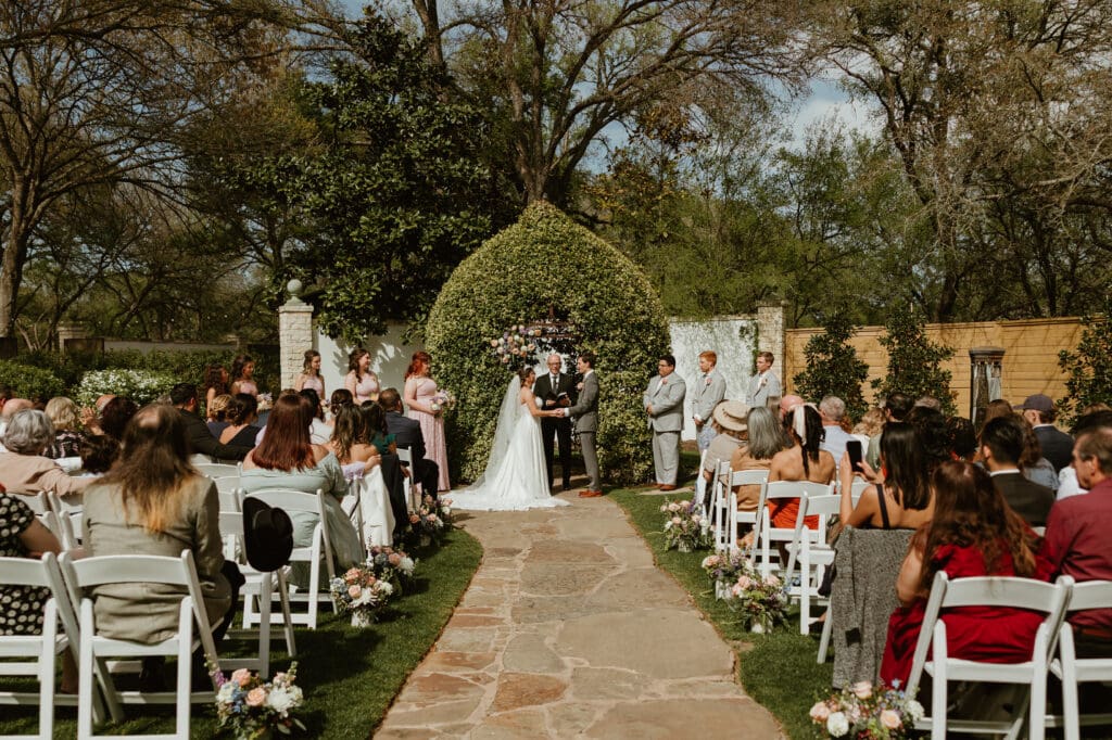 Bride and groom exchanging vows during the outdoor ceremony at The Hummingbird House in Austin TX