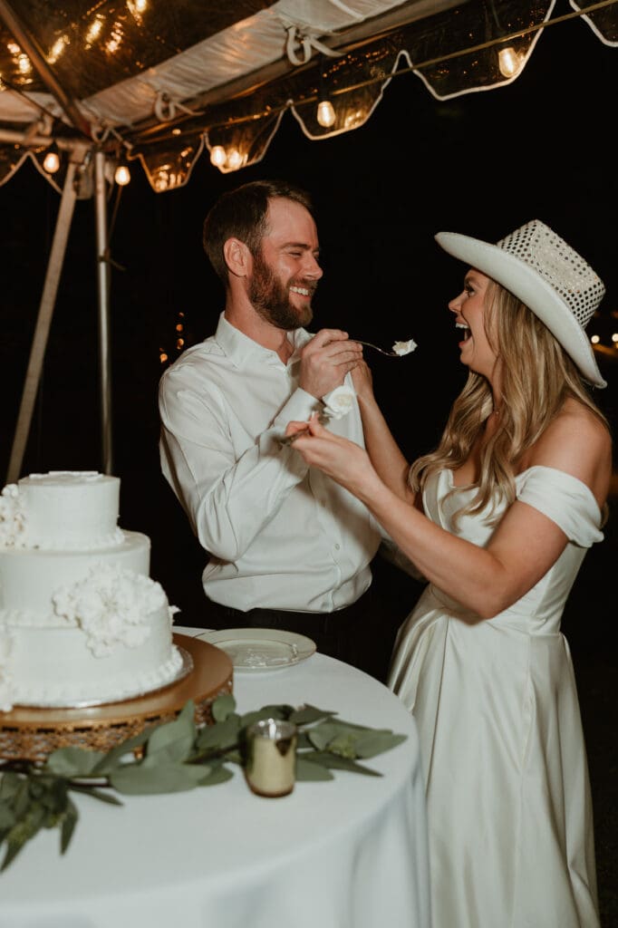 Bride and groom enjoying their cake cutting on a Spring evening outdoor at an Austin Texas wedding venue