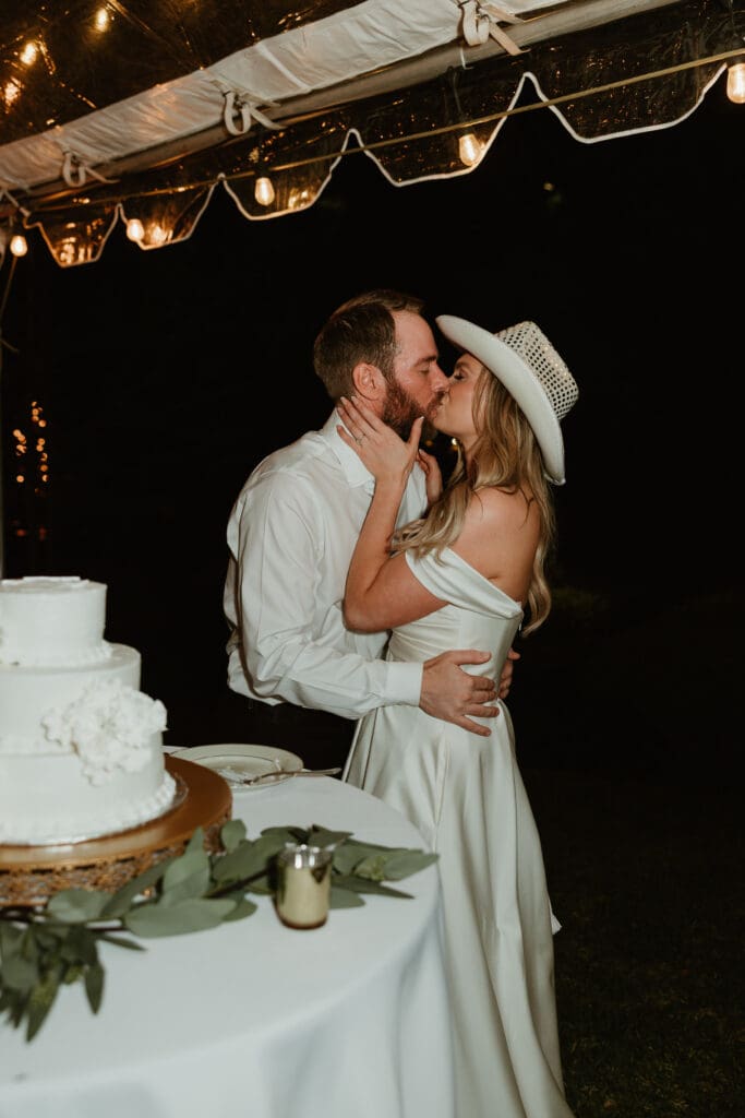 Bride and groom enjoying their cake cutting on a Spring evening outdoor at an Austin Texas wedding venue