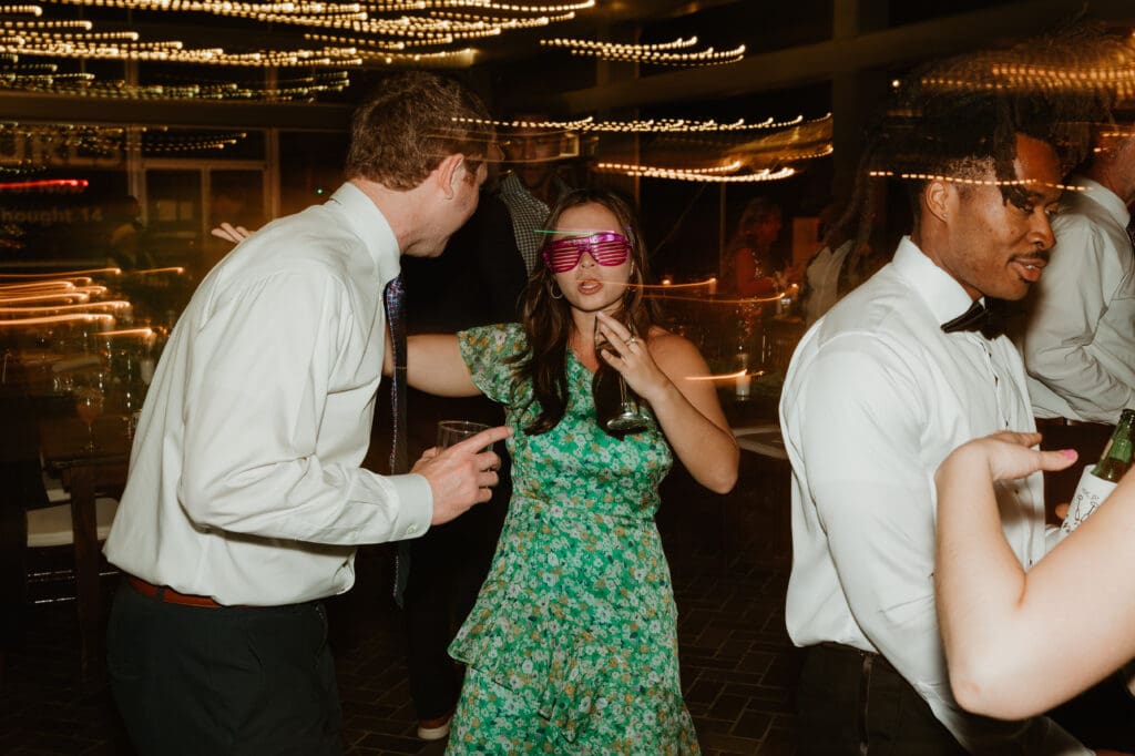 Candid moments of guests at a wedding reception at The Umlauf Sculpture Garden in Austin