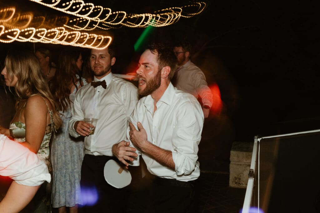 Candid moments of guests at a wedding reception at The Umlauf Sculpture Garden in Austin