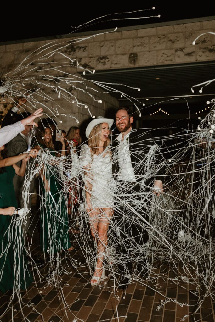 Bride and groom embracing their send off at wedding venue in Austin, Texas.