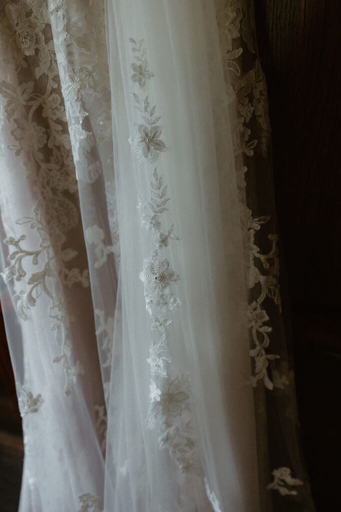 Bride's dress hanging on dresser at Jackson NH Wedding
