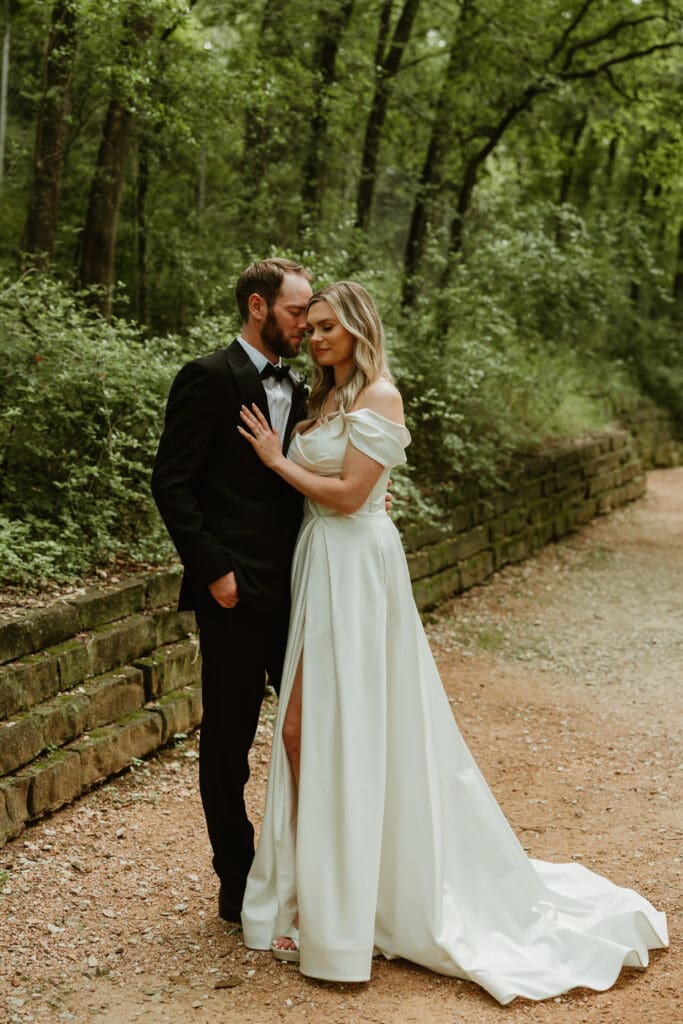 Outdoor bride and groom portraits in lush pathway during Spring in Austin Texas