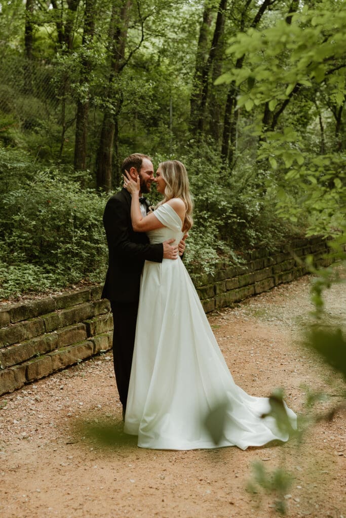 Outdoor bride and groom portraits in lush pathway during Spring in Austin Texas