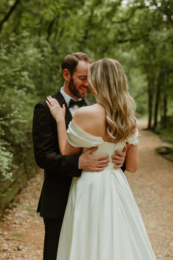 Outdoor bride and groom portraits in lush pathway during Spring in Austin Texas
