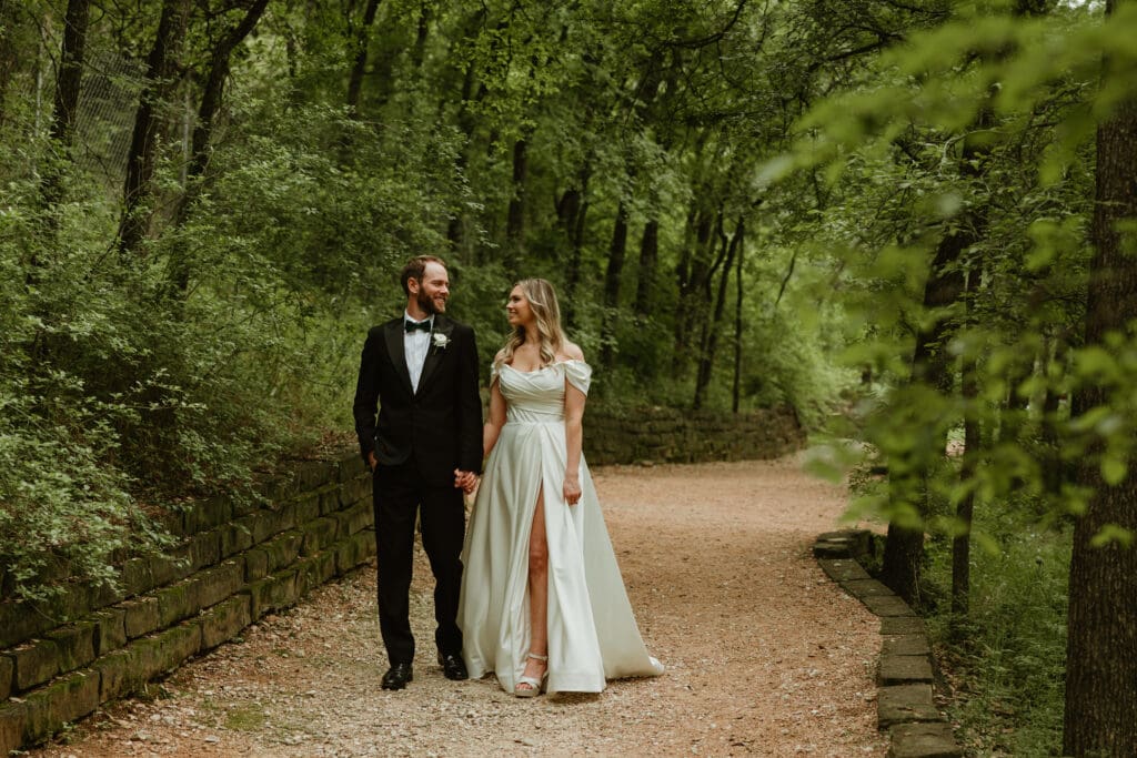 Bride and groom enjoy a stroll in lush garden during Spring in Austin Texas