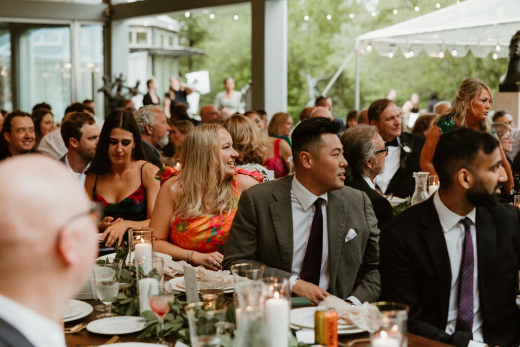 Candid moments of guests at a wedding reception at The Umlauf Sculpture Garden in Austin