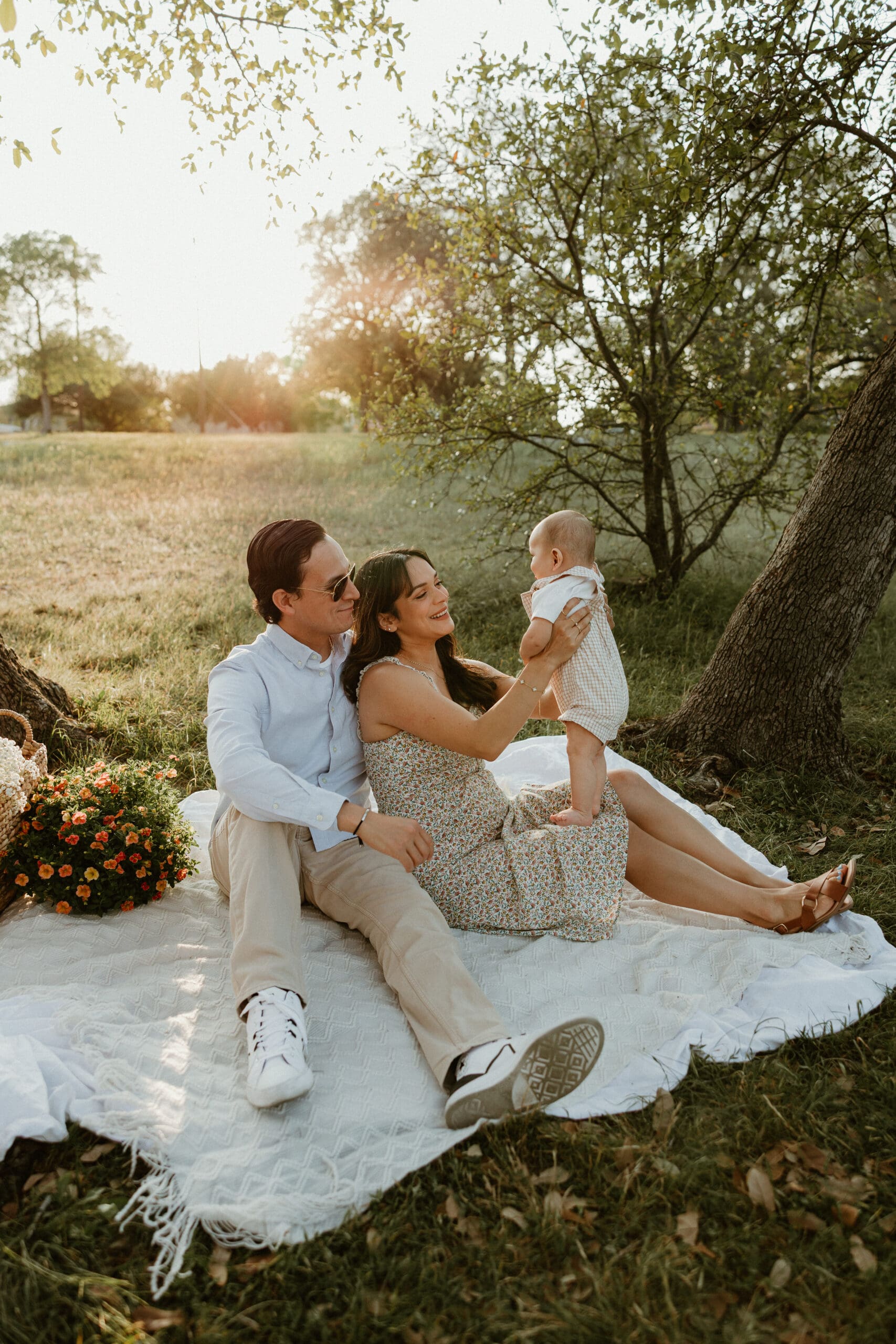 Family of three enjoying time together during golden hour at Balcones District Park in North Austin