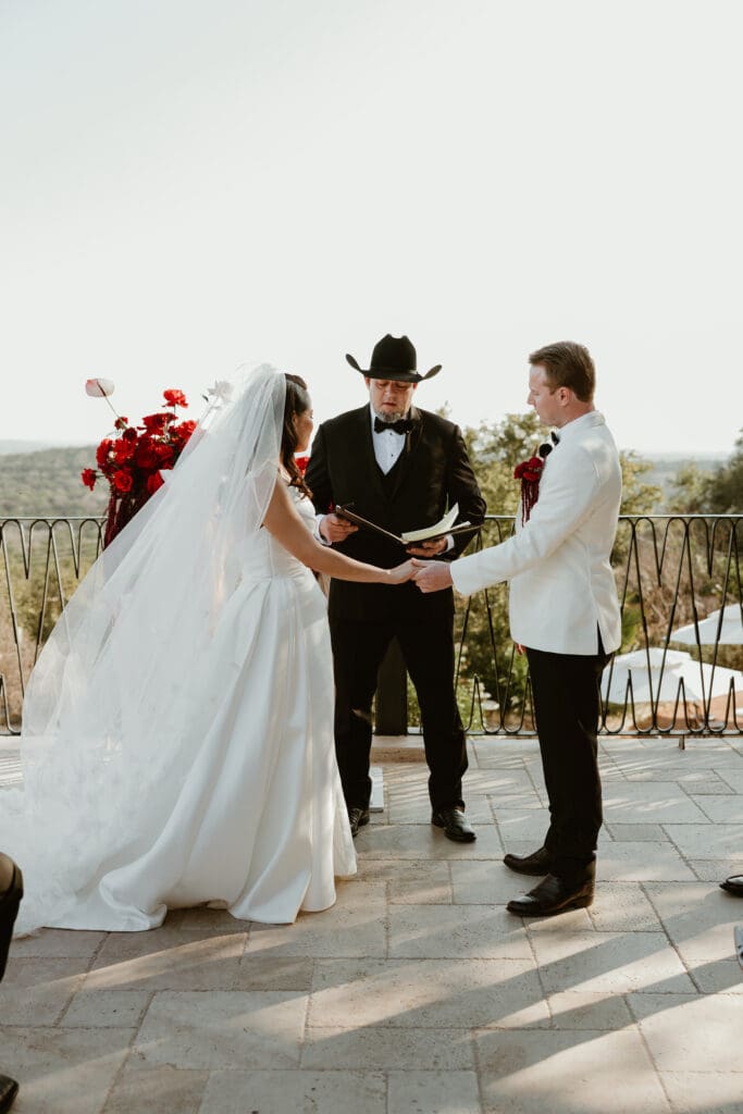 Bride and groom exchanging vows on the outdoor terrace at Villa Antonia.

