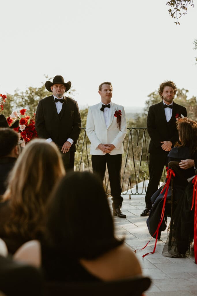 Groom awaiting brides entrance down the aisle on Villa Antonia courtyard.