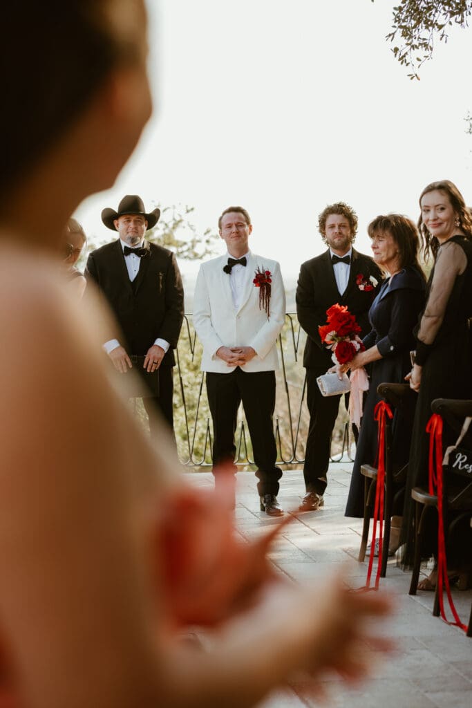 Candid moments of groom awaiting brides entrance down the aisle on Villa Antonia courtyard.