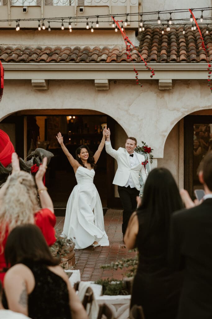 Bride and groom celebrate their marriage as they enter reception at Villa Antonia.
