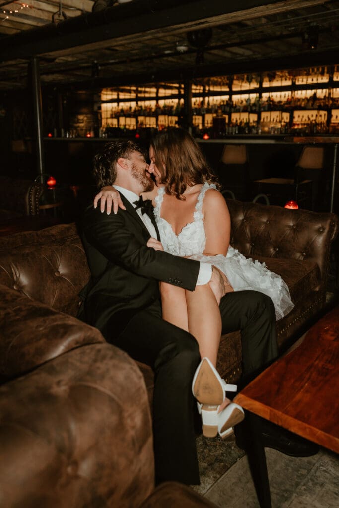 Engaged couple share a kiss in downtown Austin bar