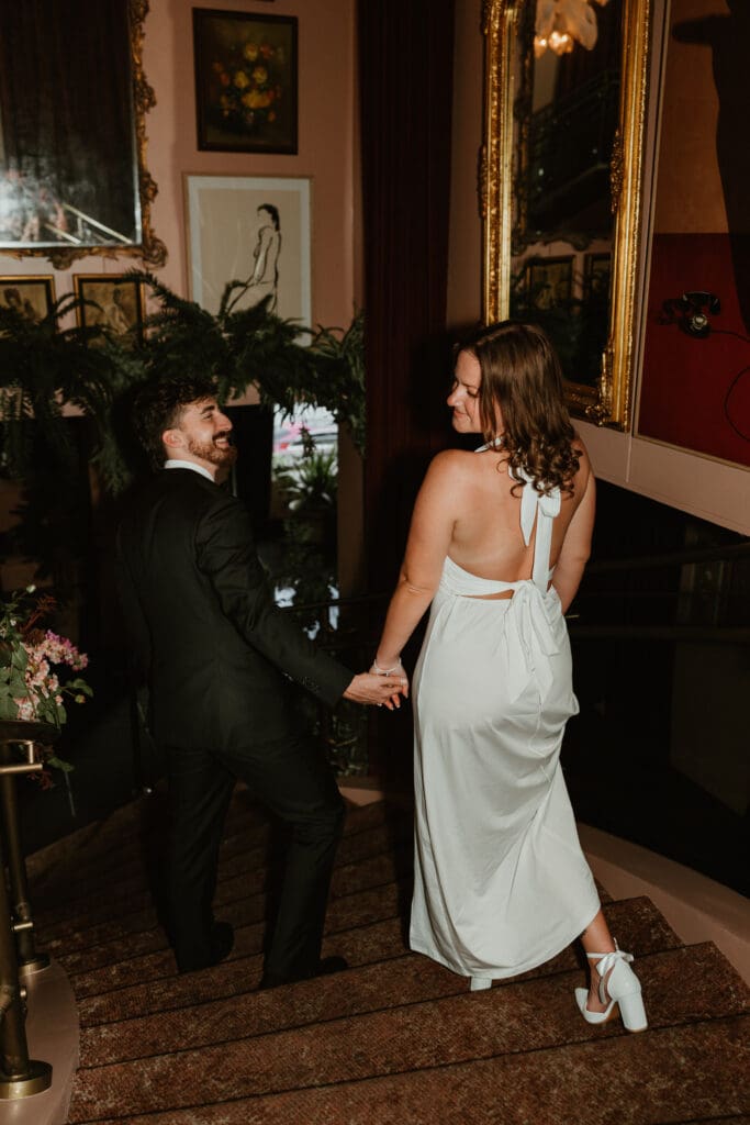 Engaged couple holding hands in popular downtown Austin bar