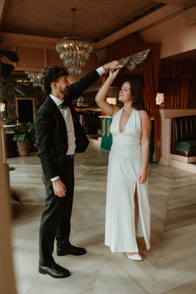 Engaged couple share a private dance in downtown Austin bar. 