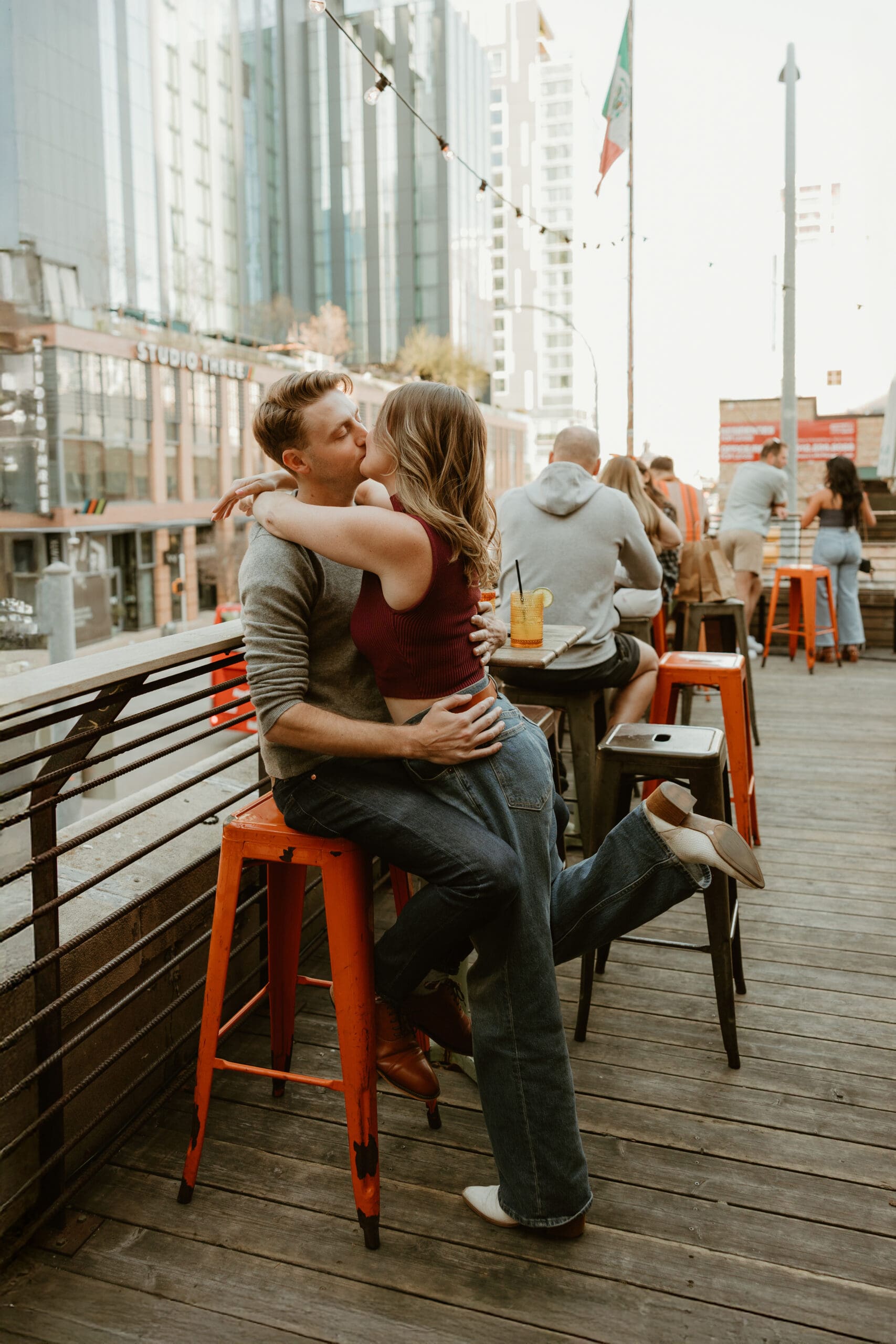 Couple sharing a kiss on Downtown Austin bar rooftop