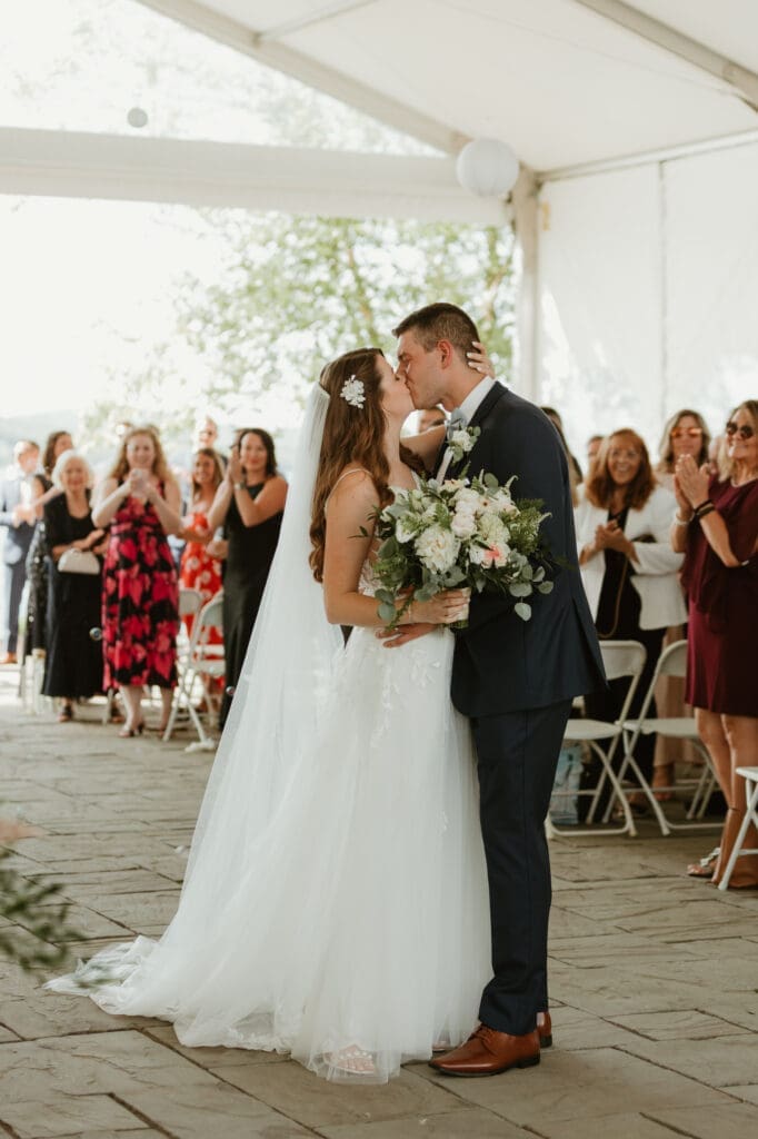 Bride and groom exchange kiss at The Margate NH wedding venue.